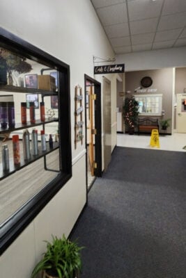 Hallway in Orland, Maine business plaza showing various businesses including a local hair salon