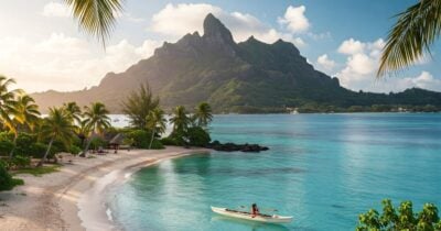 Beach with village and boats in Tahiti
