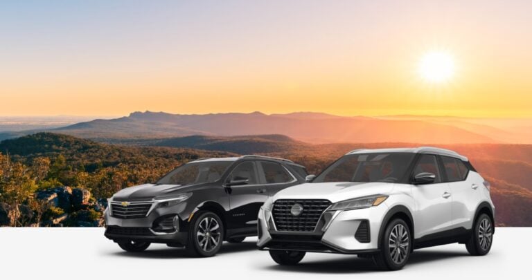 View of Hertz SUVs available for car rental, with sunset and mountains in background