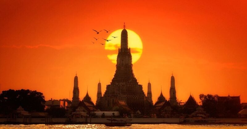 Golden hour at Wat Arun, Bangkok; a prime destination for budget-luxury travelers in Thailand.